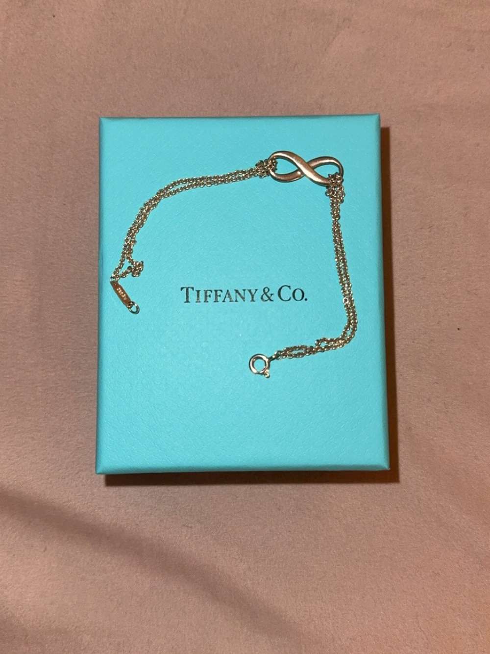 Tiffany & Co. Gold Infinity Bracelet on Blue Box